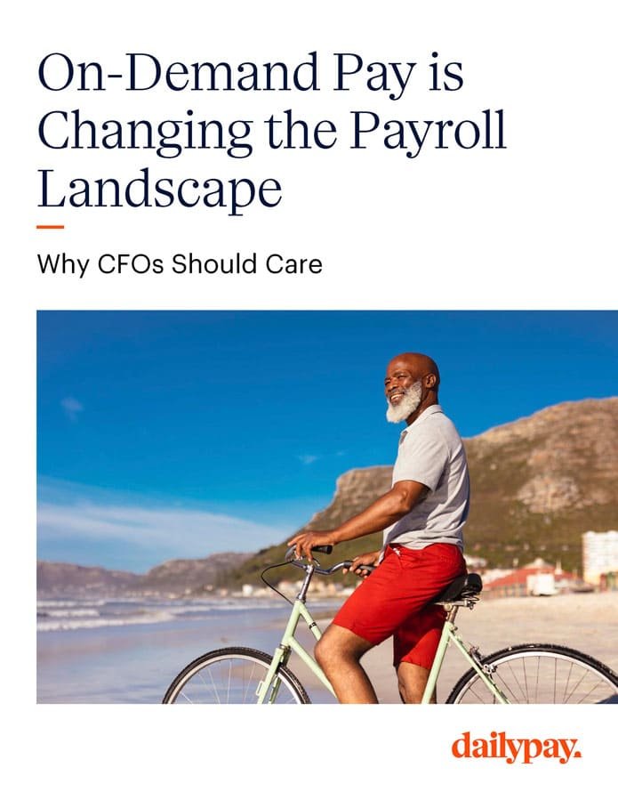 A gray-bearded man wearing a light gray polo shirt and red shorts rides a bicycle on a paved path with a beach and mountains in the background. The text above reads, "On-Demand Pay is Changing the Payroll Landscape" and below it, "Why CFOs Should Care About Pay On Demand Providers." The logo "dailypay" is at the bottom right.