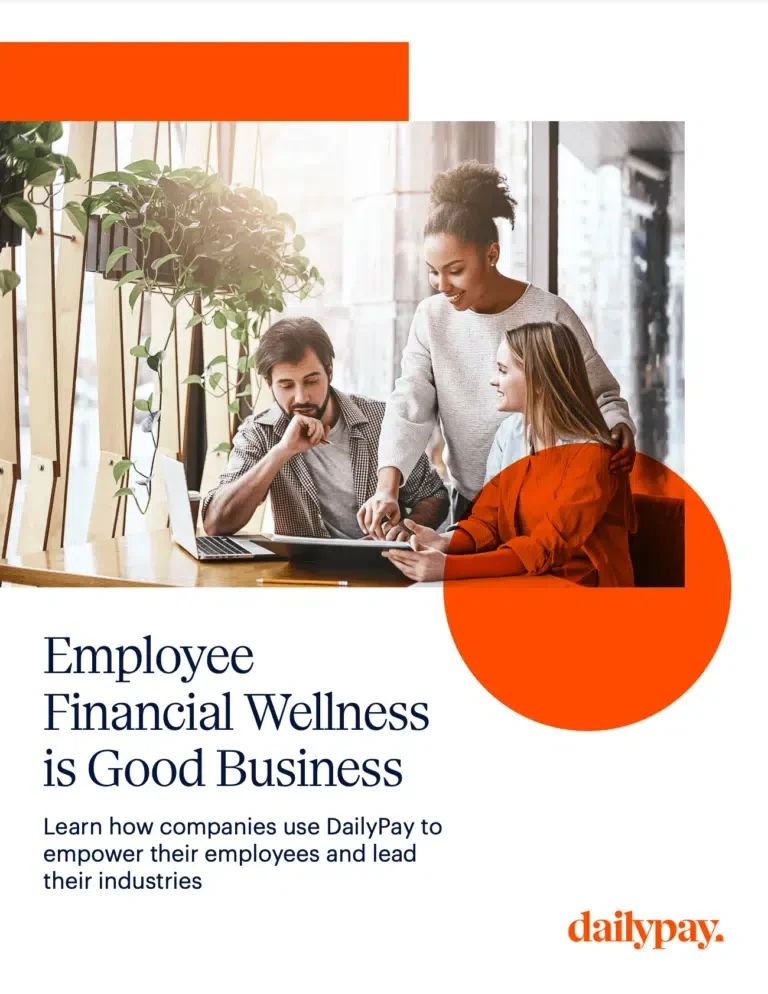 Three colleagues discuss work on a laptop in a modern office. Text on the image reads, "Employee Financial Wellness is Good Business. Learn how companies use DailyPay to empower their employees and lead their industries.