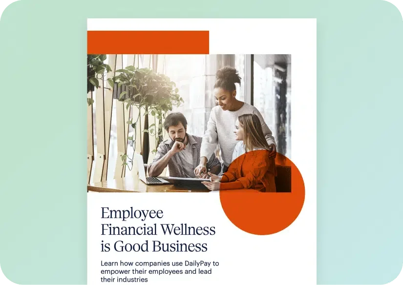 Three colleagues are gathered around a desk, looking at a laptop. One person is standing, while two are seated. The text reads, "Employee Financial Wellness is Good Business.