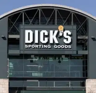 Exterior view of a Dick's Sporting Goods store featuring a large sign with the store's name and logo above the entrance.