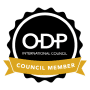 A black circular badge with a scalloped edge. Inside the circle, the text reads "ODP International Council" in white on a black background. A gold ribbon across the bottom portion of the circle reads "Council Member" in white text.