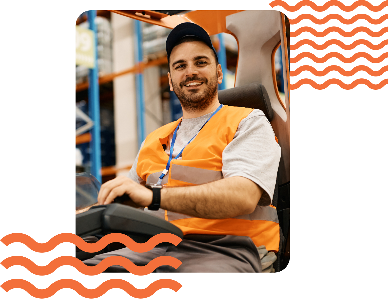 Man in an orange safety vest and cap sitting in a forklift, smiling, in a warehouse setting.